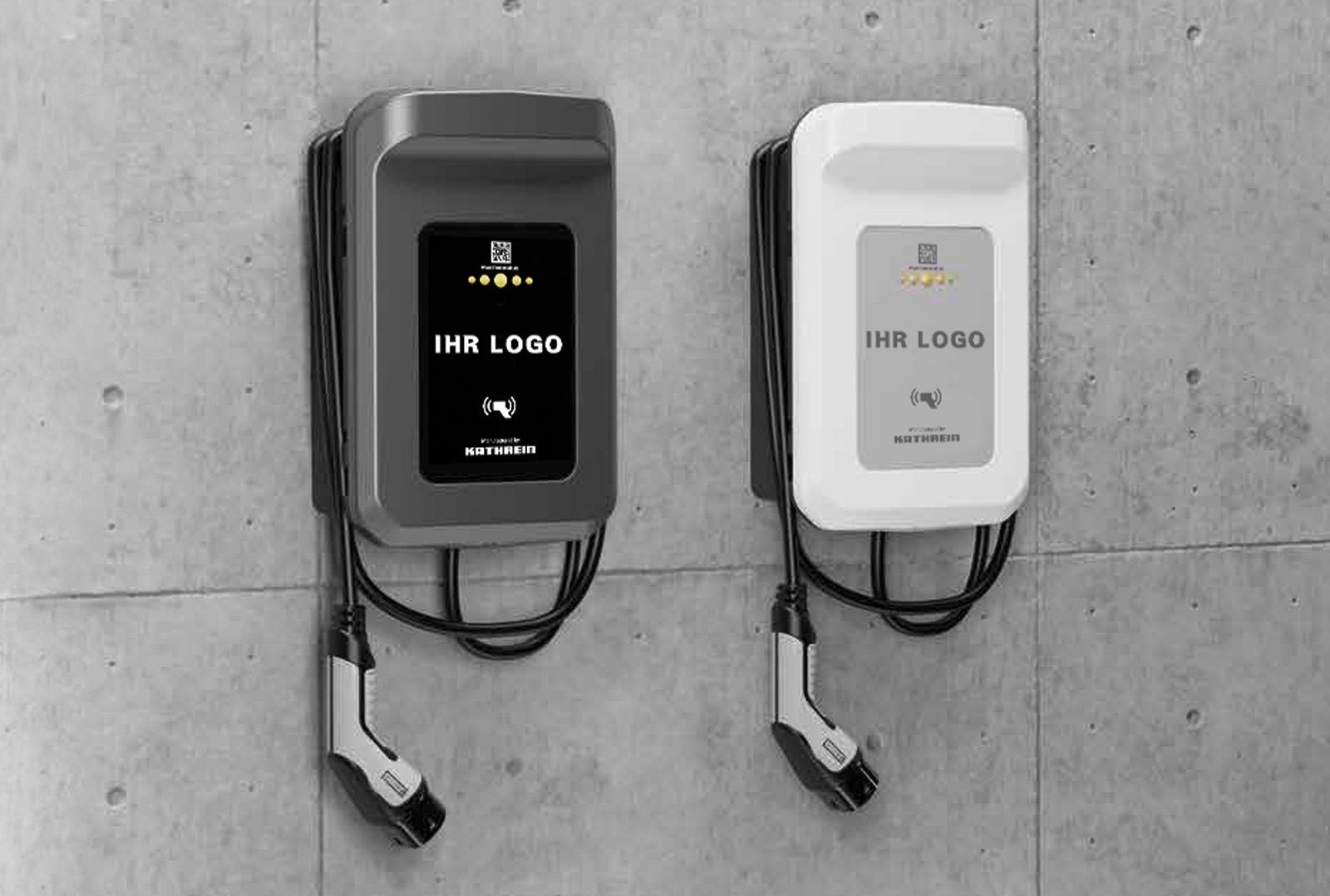 Two modern wallboxes in black and white with the lettering 'YOUR LOGO' on a concrete wall - symbolize individual white label charging solutions for electromobility